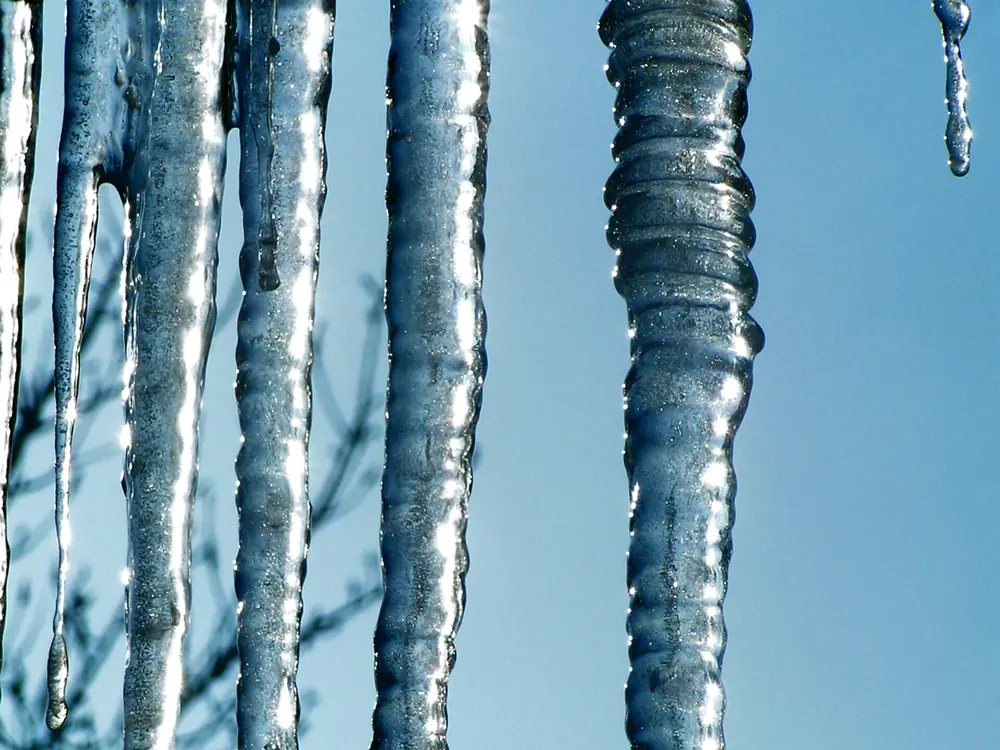 Long icicles hanging from a roof edge